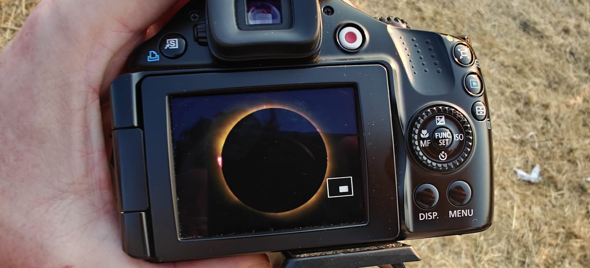 a dslr screen showing a great photo of the eclipsed Sun